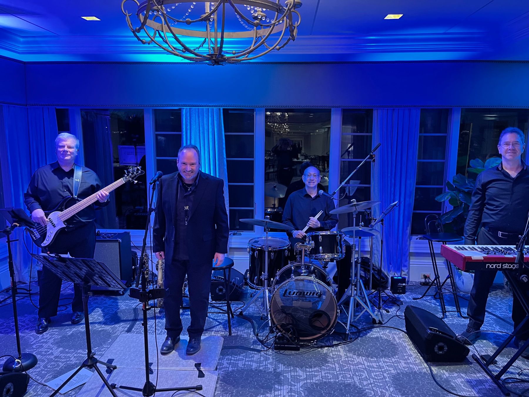 Blue Abyss on stage under blue lights: Craig Beattie on bass, Damian Cremision, Patrick Martucci on drums and Scott Woska on keys.