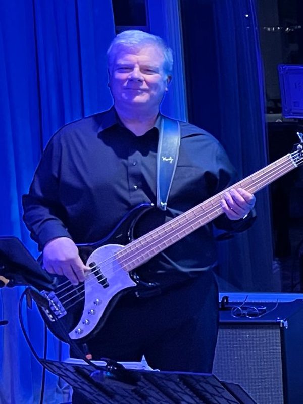Craig Beattie holding his bass.