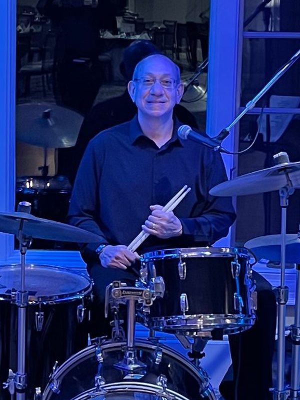 Patrick Martucci smiling behind his Ludwig drum kit.